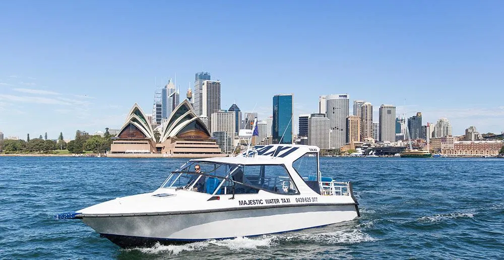 Majestic water taxi in front of the Sydney Opera House and city skyline