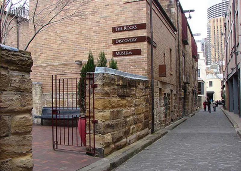 A person walking up the cobbled laneway in the Rocks