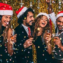 Friends celebrating at a Christmas party in Santa hats