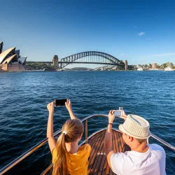 Father and child photographing the Harbour Bridge from a boat