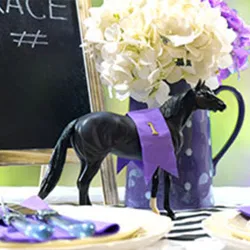 Melbourne Cup table setting with horse figurine and flowers