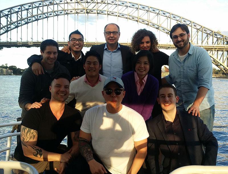 Corporate group on the deck of a water taxi in front of the Sydney Harbour Bridge