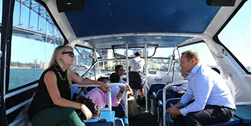 Guests seated in the cabin of a Majestic water taxi