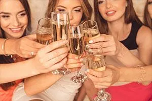 Hens party guests raising a champagne toast