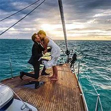 Marriage proposal on a boat deck at sunset